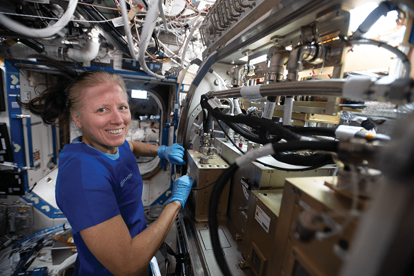 image of an astronaut working with an experiment