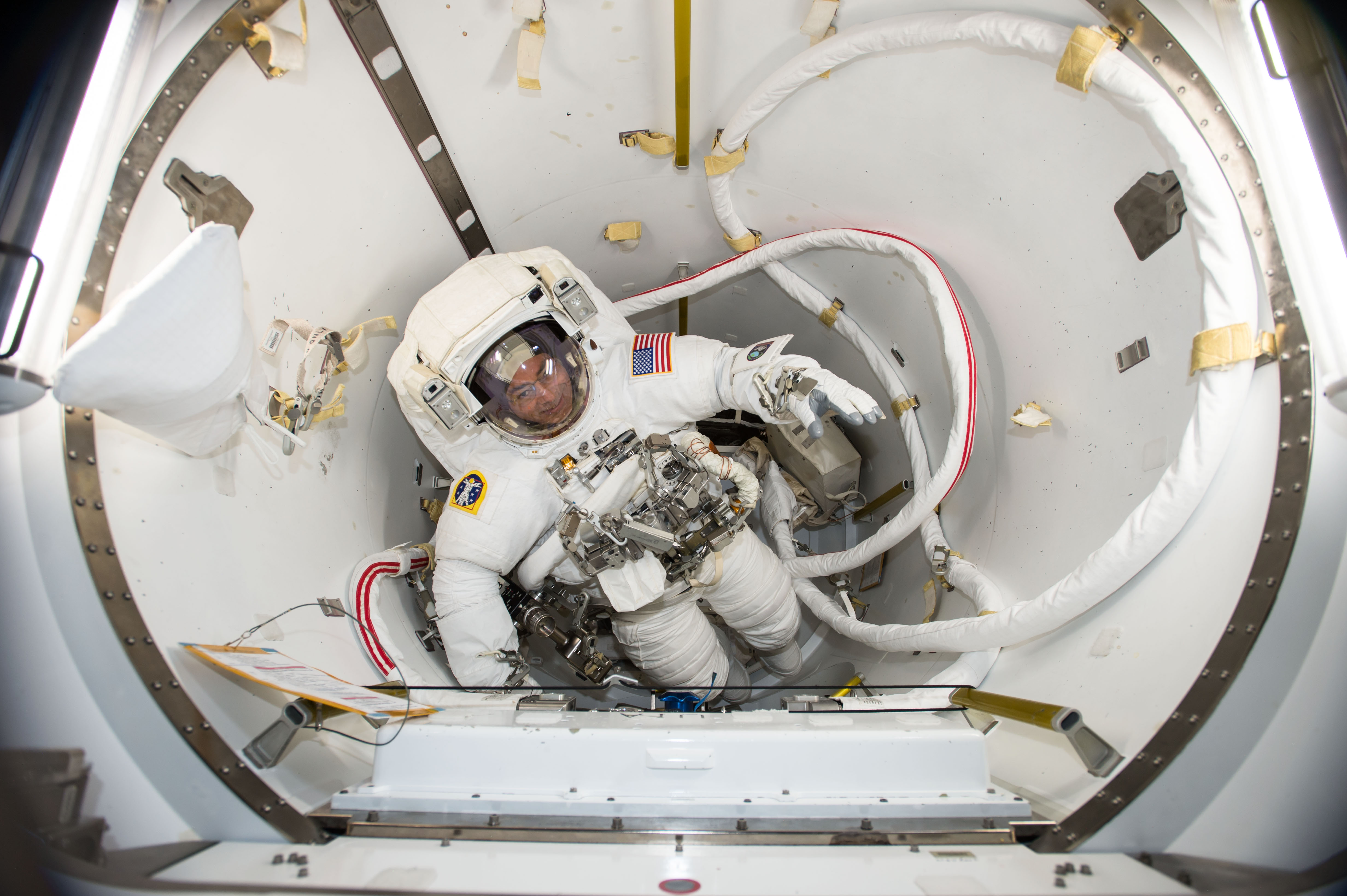 NASA astronaut and Expedition 53 Flight Engineer Mark Vande Hei verifies his U.S. spacesuit fits while inside the International Space Station's U.S...